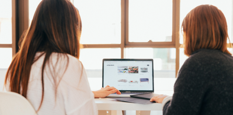 Marketers looking at an interface in a laptop together.