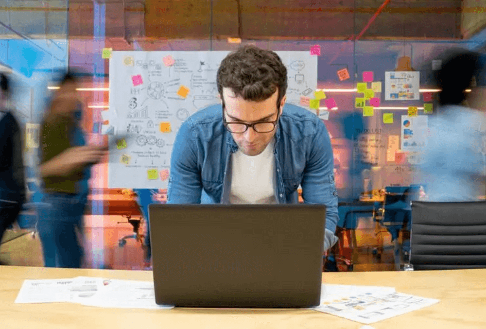 man typing on his laptop