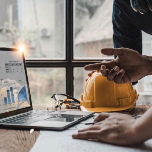 Contractors reviewing digital marketing campaign analytics on a laptop