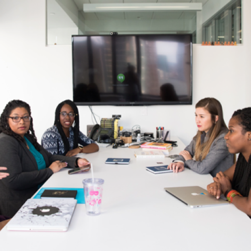 Group of digital marketers having a discussion in a conference room.